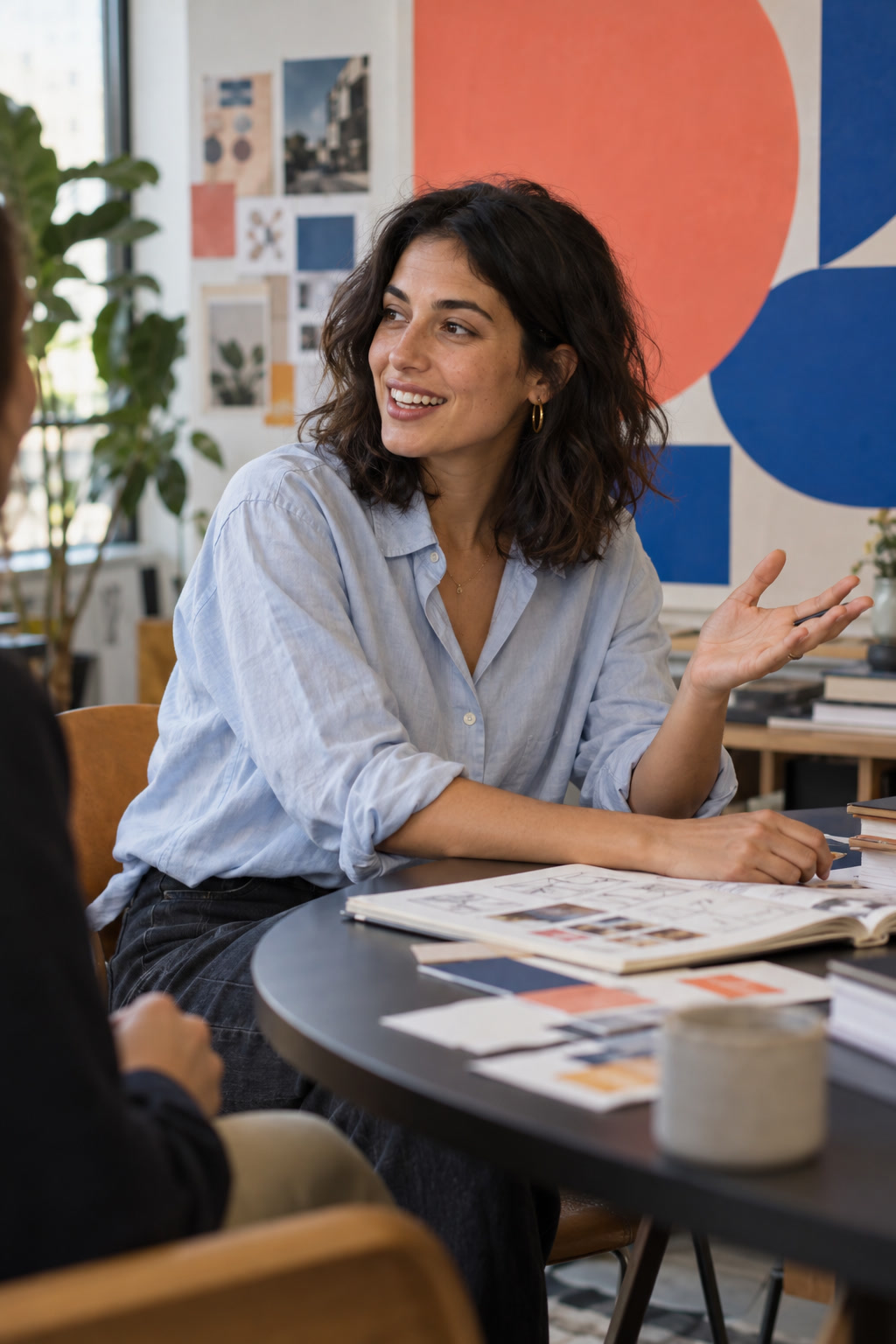 Creative strategist speaking at a colourful studio meeting